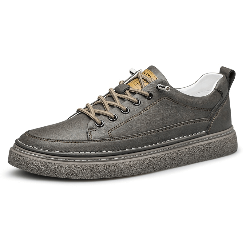 Grey leather men's sneakers with lace-up design, featuring breathable material and sturdy rubber sole for stylish athletic or casual wear.